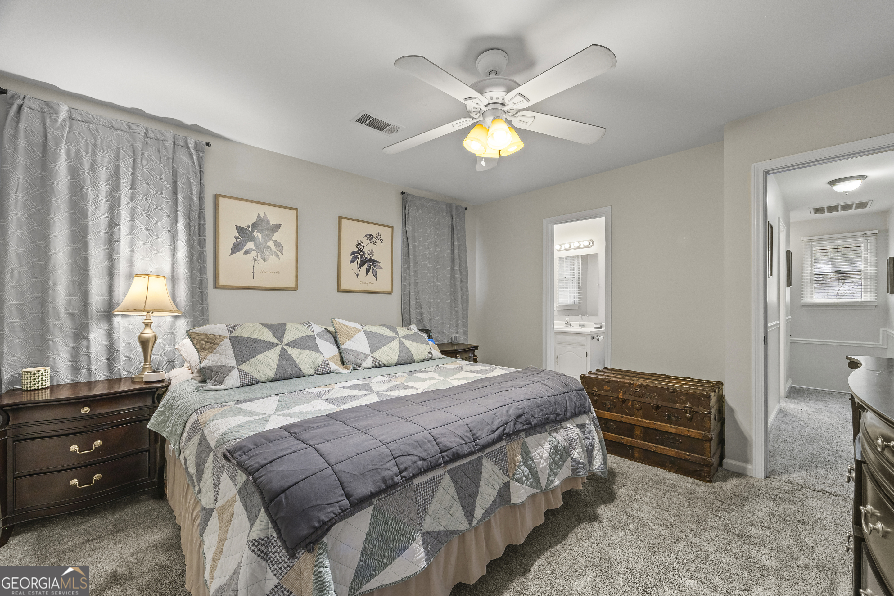 129 Pheasant Run Bogart, GA 30622 - Photo 32 of 50 a bedroom with a bed and a chandelier