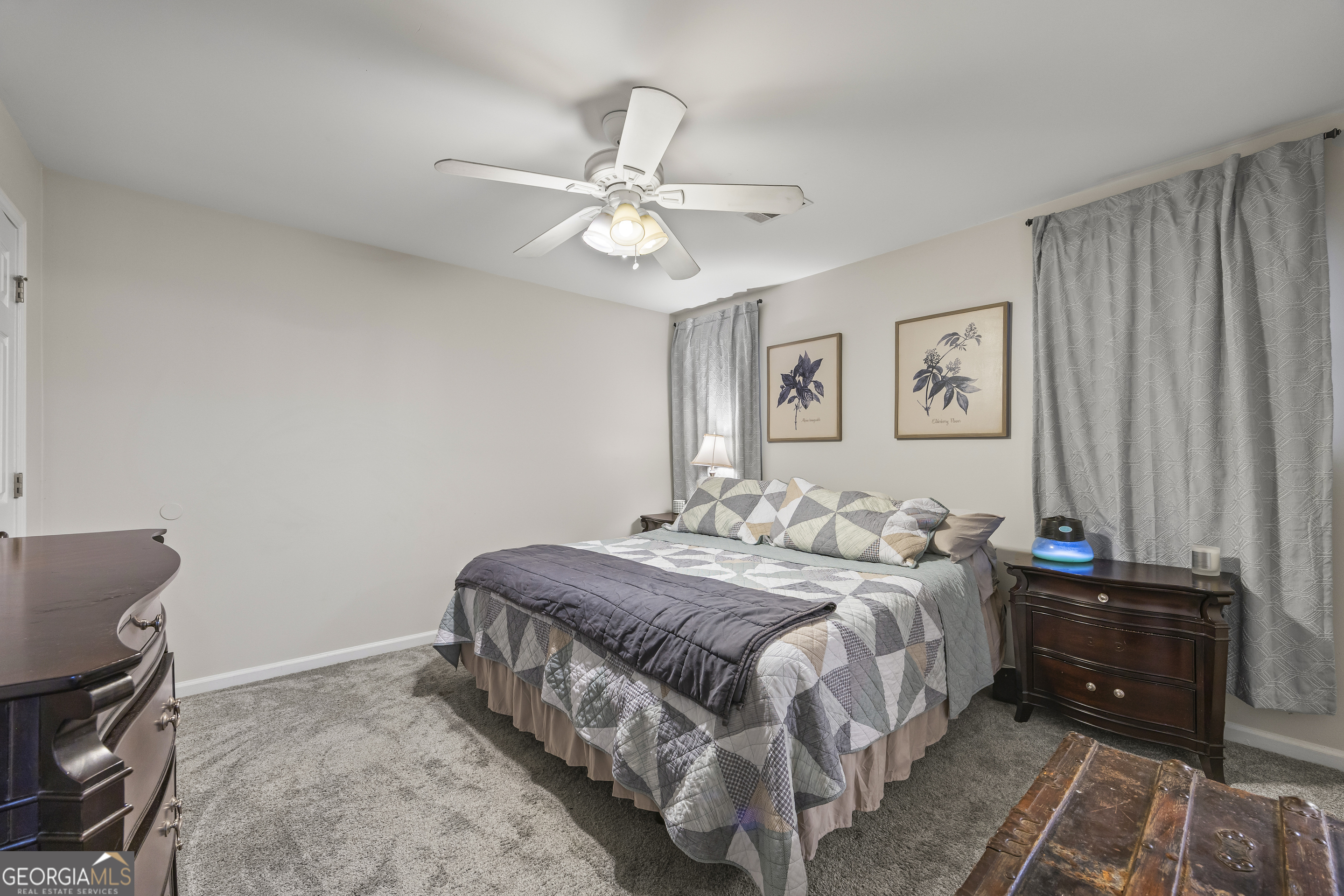 129 Pheasant Run Bogart, GA 30622 - Photo 33 of 50 a bedroom with a bed and a chandelier