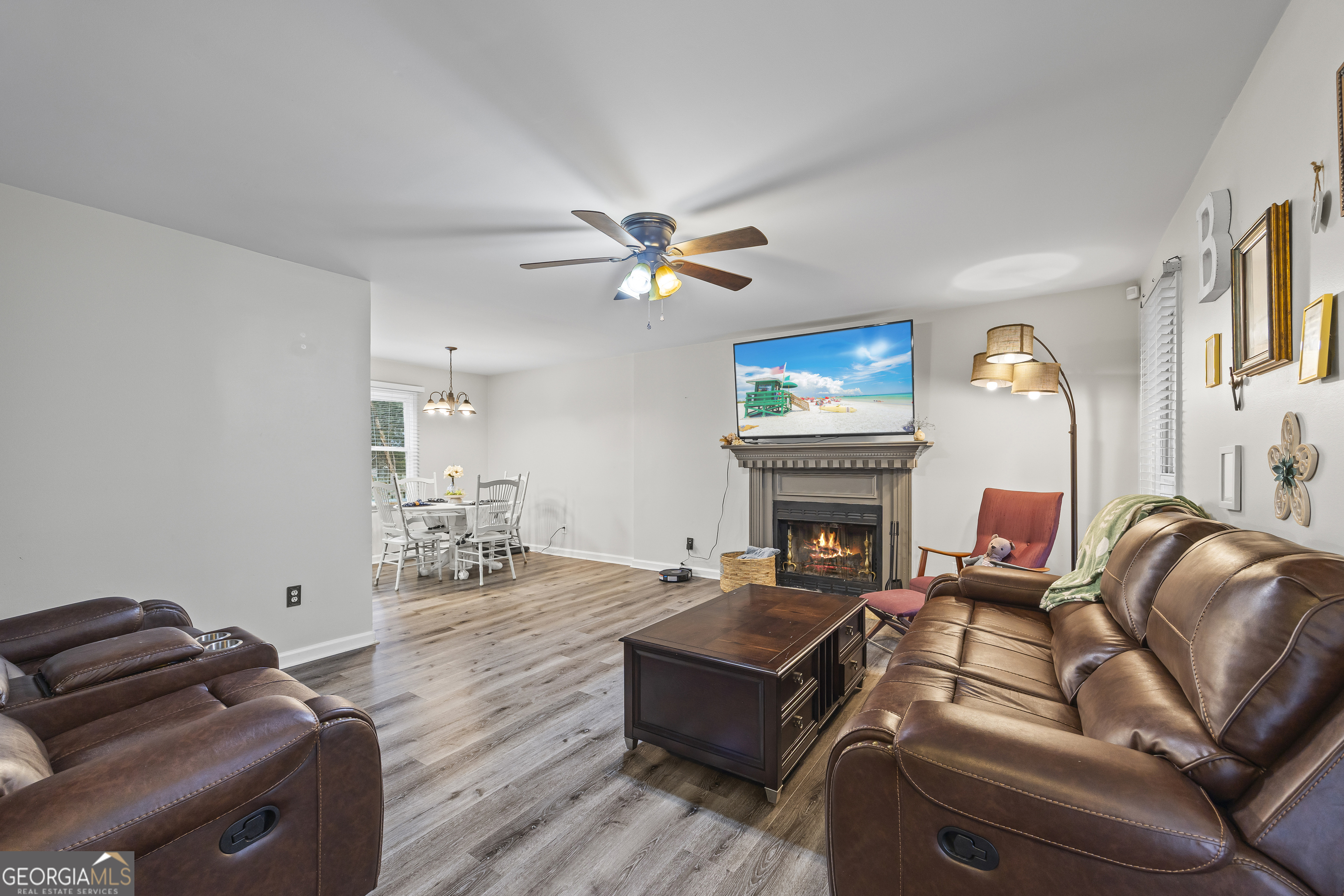 129 Pheasant Run Bogart, GA 30622 - Photo 10 of 50 a living room with furniture a fireplace and a flat screen tv