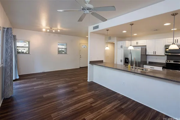 a view of a kitchen counter top and wooden floor