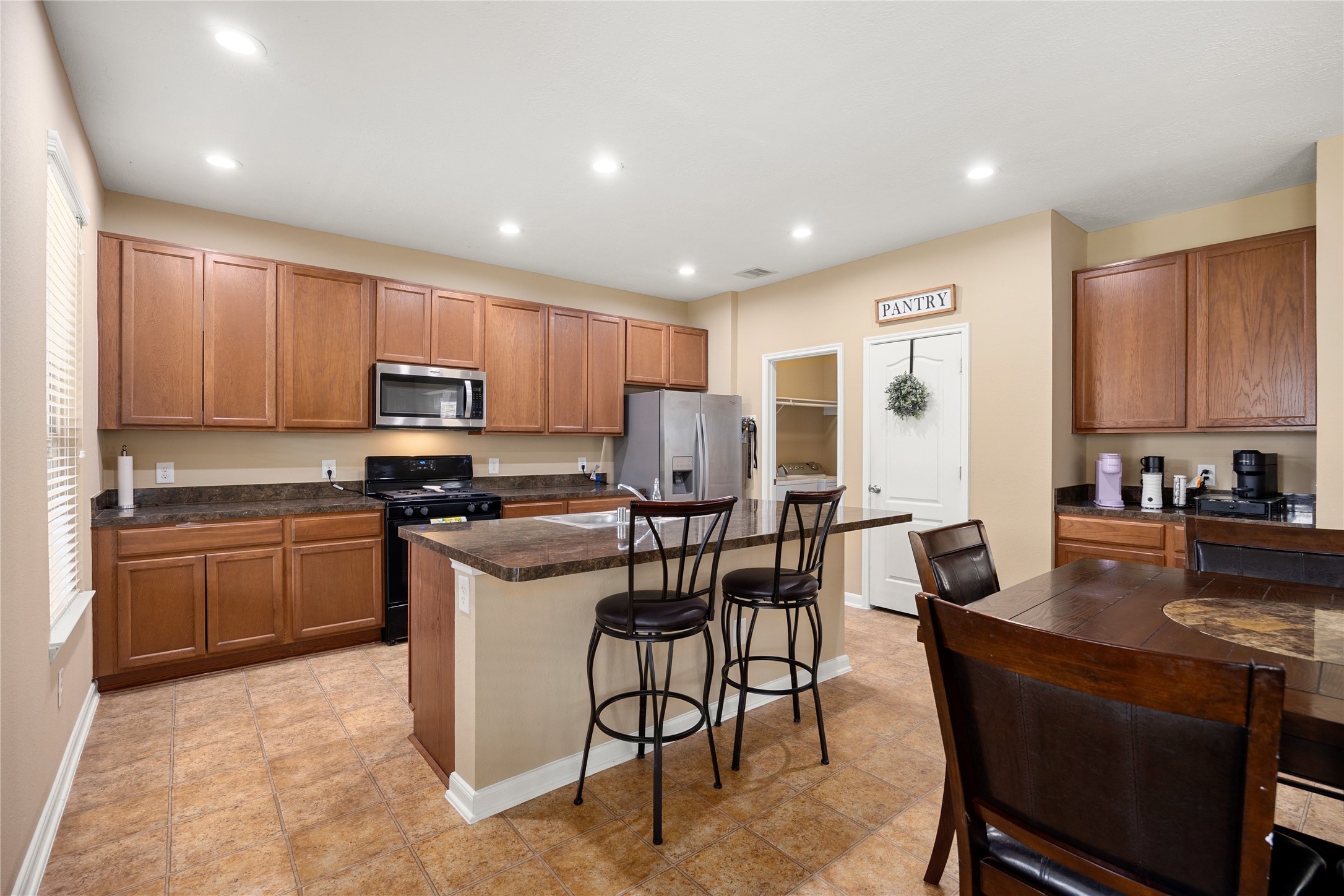 22414 Bellwick Ridge Lane Katy, TX 77449 - Photo 8 of 23 Spacious kitchen with abundant cabinetry, generous counter space, and a walk-in pantry. Perfectly designed for both everyday living and entertaining.