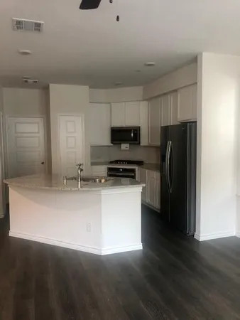 a kitchen with stainless steel appliances a refrigerator and a stove top oven