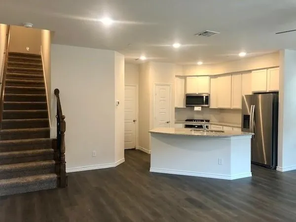 a kitchen with stainless steel appliances a sink and a refrigerator