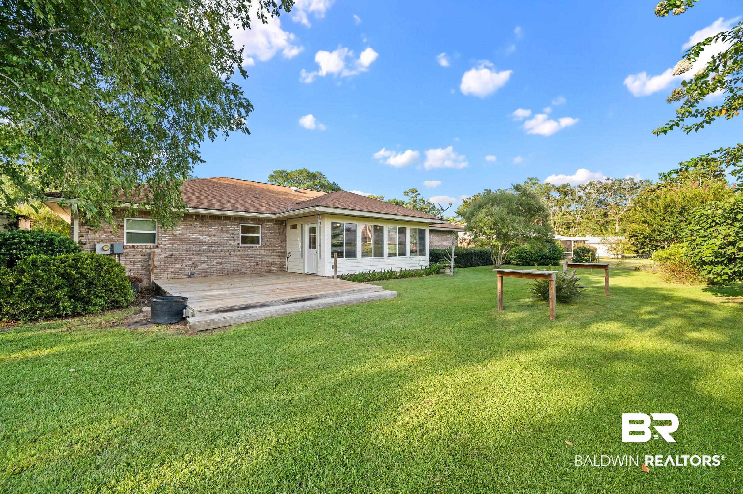 303 West Palm Avenue Foley, AL 36535 - Photo 29 of 32 Exterior space with a wooden deck and a yard