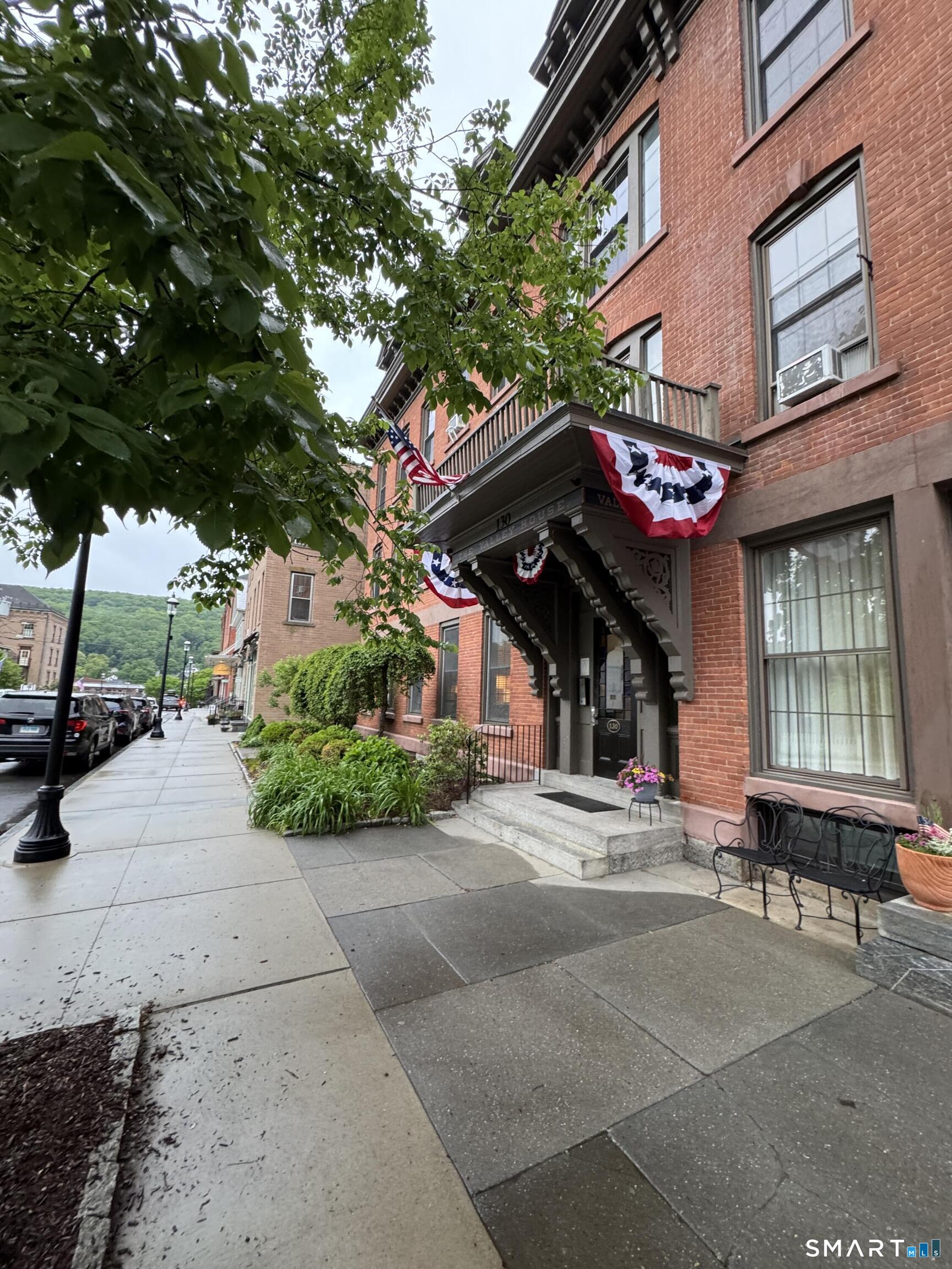 130 Main Street, Unit 2D Canton, CT 06019 - Photo 2 of 25 a view of a building with a tree in front