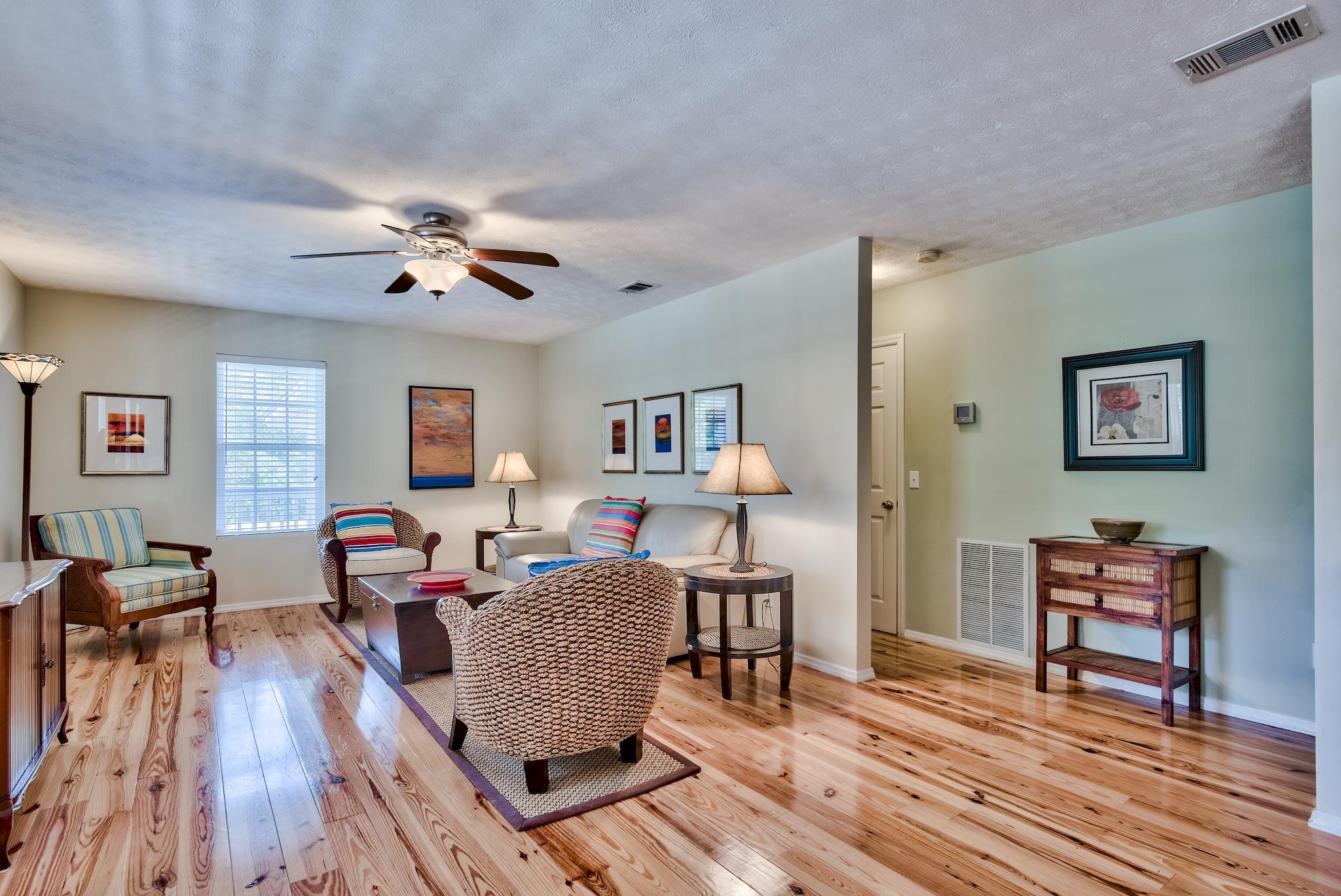 197 Acacia Street Santa Rosa Beach, FL 32459 - Photo 11 of 40 a living room with furniture and wooden floor