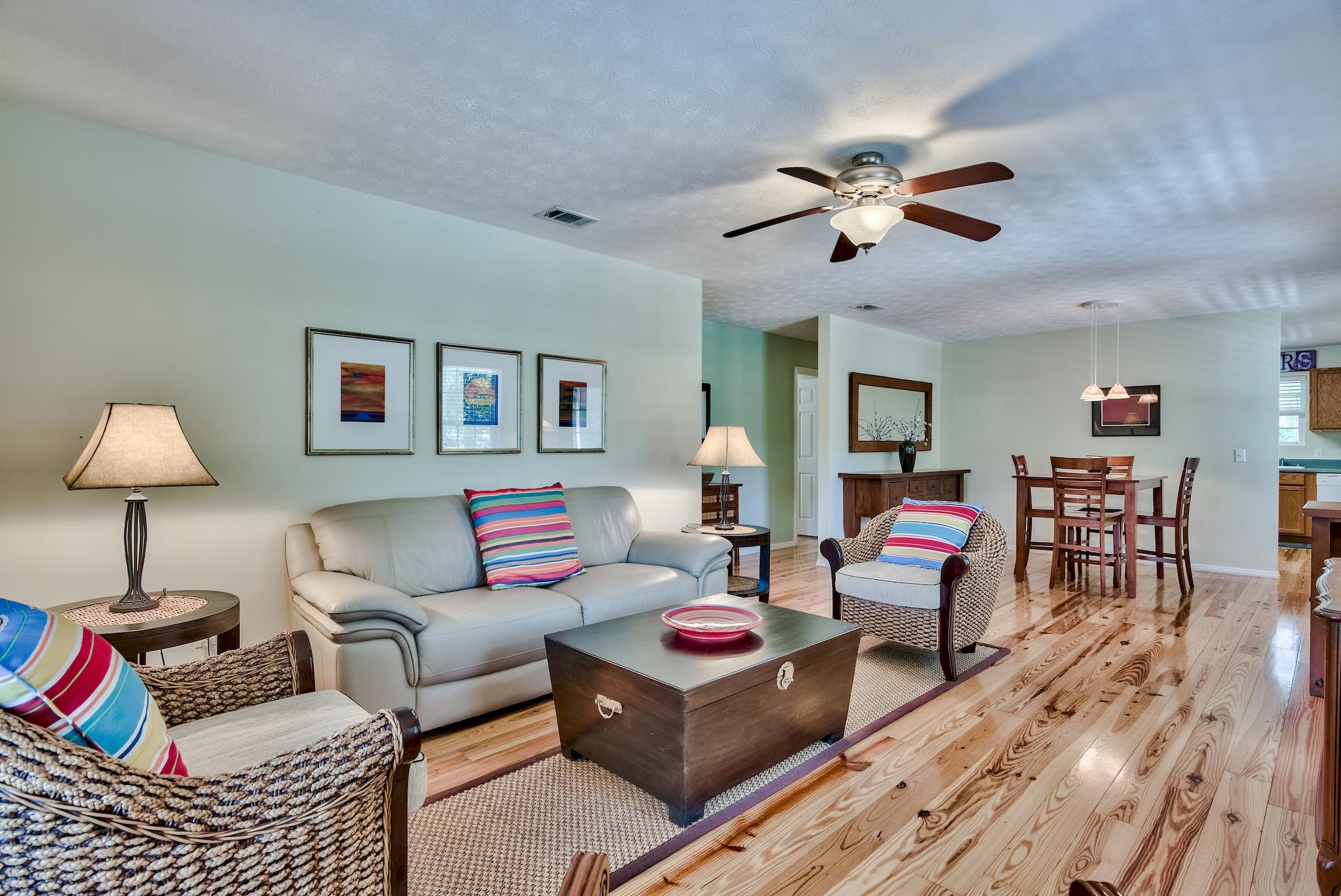 197 Acacia Street Santa Rosa Beach, FL 32459 - Photo 12 of 40 a living room with furniture and a wooden floor