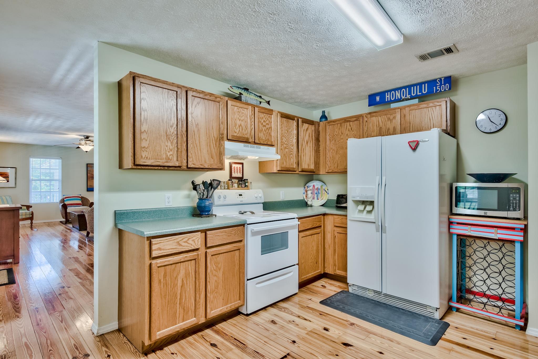 197 Acacia Street Santa Rosa Beach, FL 32459 - Photo 15 of 40 a kitchen with stainless steel appliances granite countertop a refrigerator sink and cabinets