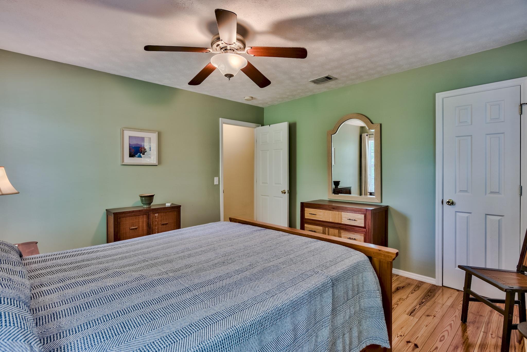 197 Acacia Street Santa Rosa Beach, FL 32459 - Photo 18 of 40 a bedroom with a bed and a chandelier