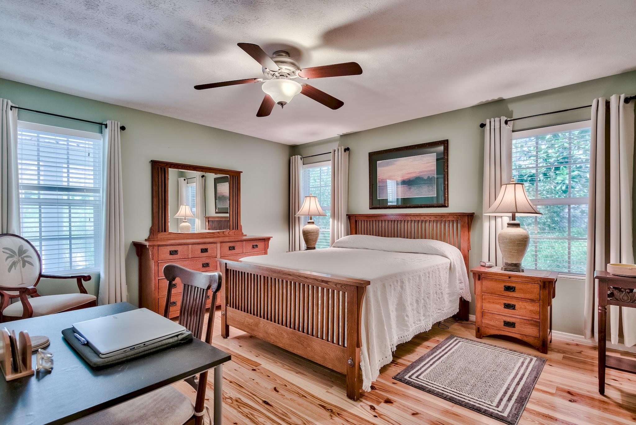 197 Acacia Street Santa Rosa Beach, FL 32459 - Photo 22 of 40 a bedroom with a bed and wooden floor