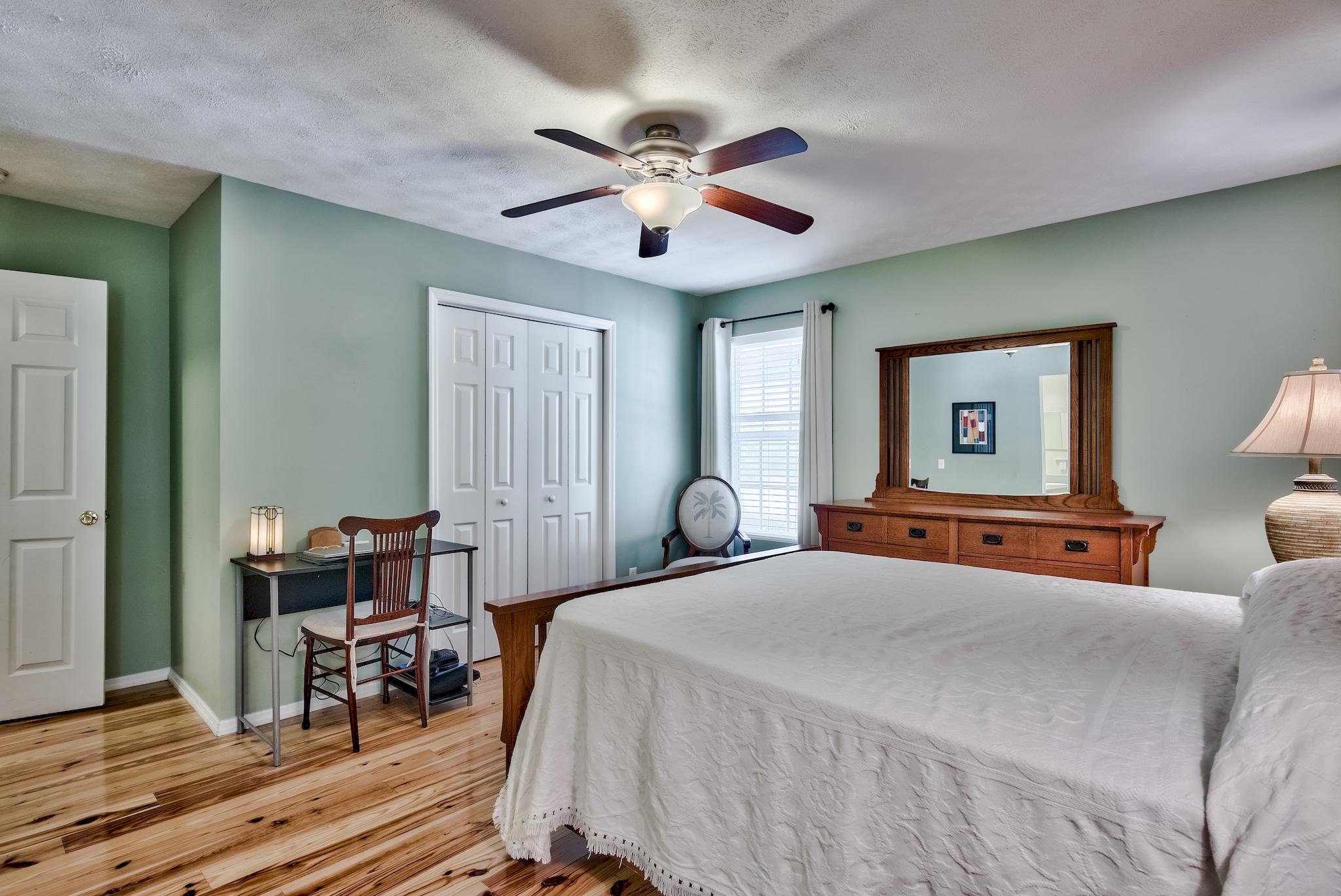 197 Acacia Street Santa Rosa Beach, FL 32459 - Photo 23 of 40 a bedroom with a bed and a chandelier