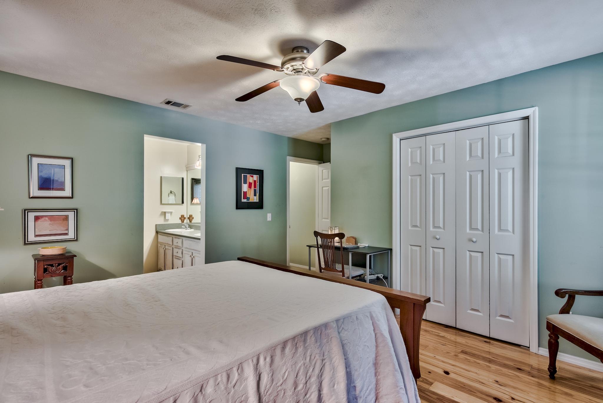 197 Acacia Street Santa Rosa Beach, FL 32459 - Photo 24 of 40 a bedroom with a large bed and a chandelier