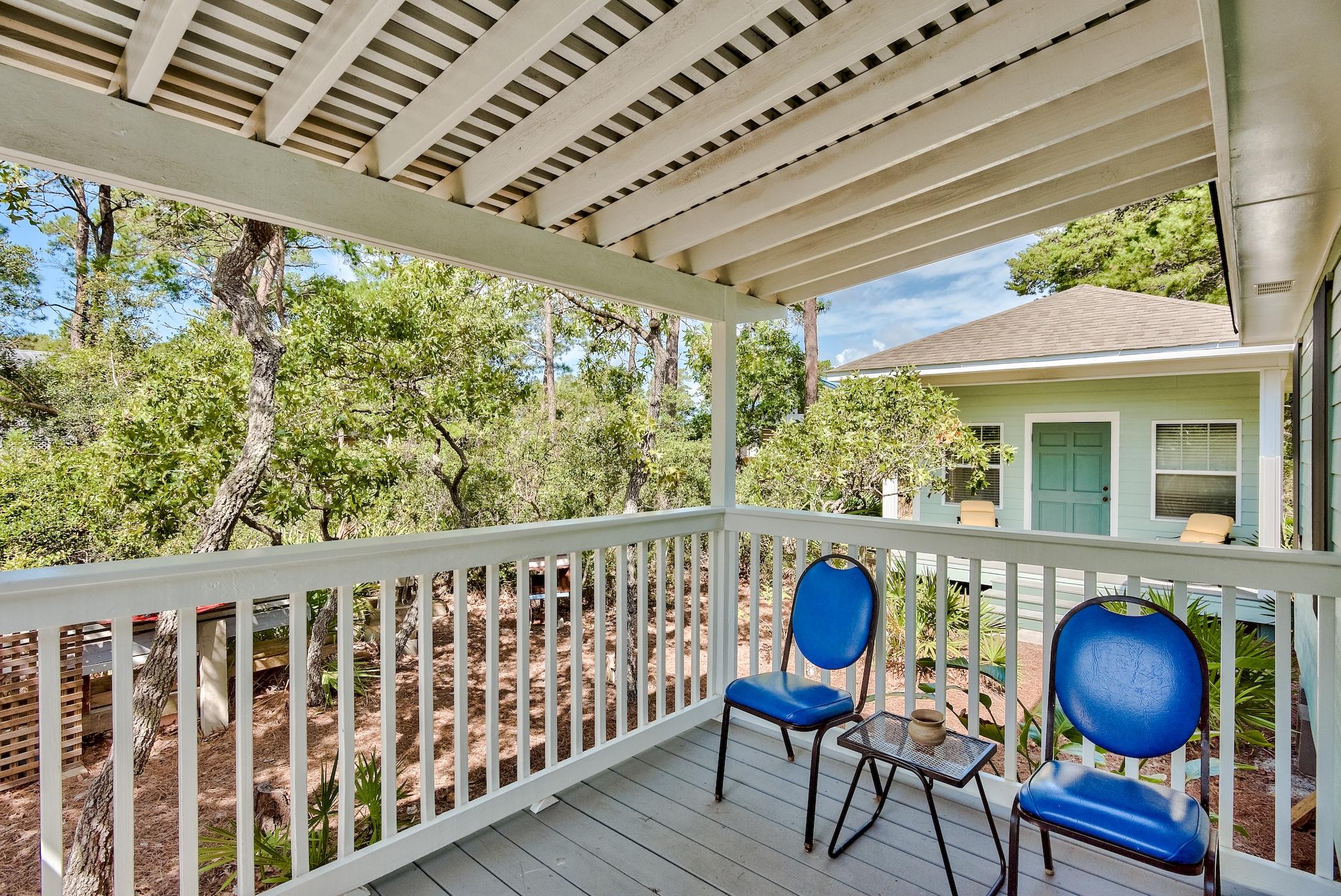 197 Acacia Street Santa Rosa Beach, FL 32459 - Photo 30 of 40 a view of balcony with wooden floor and outdoor seating