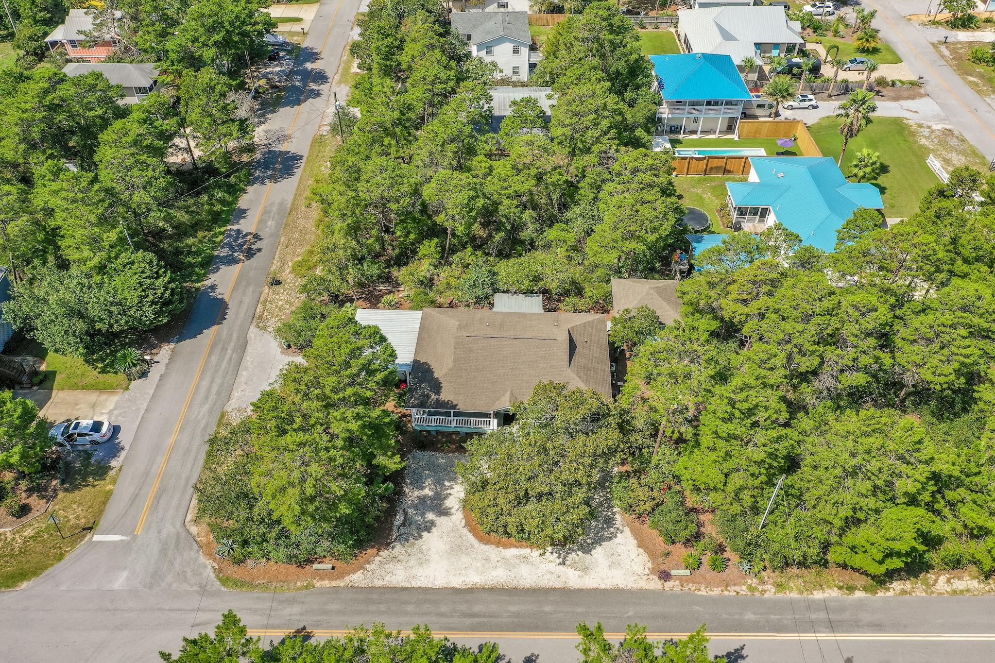 197 Acacia Street Santa Rosa Beach, FL 32459 - Photo 35 of 40 an aerial view of a house with a yard and garden