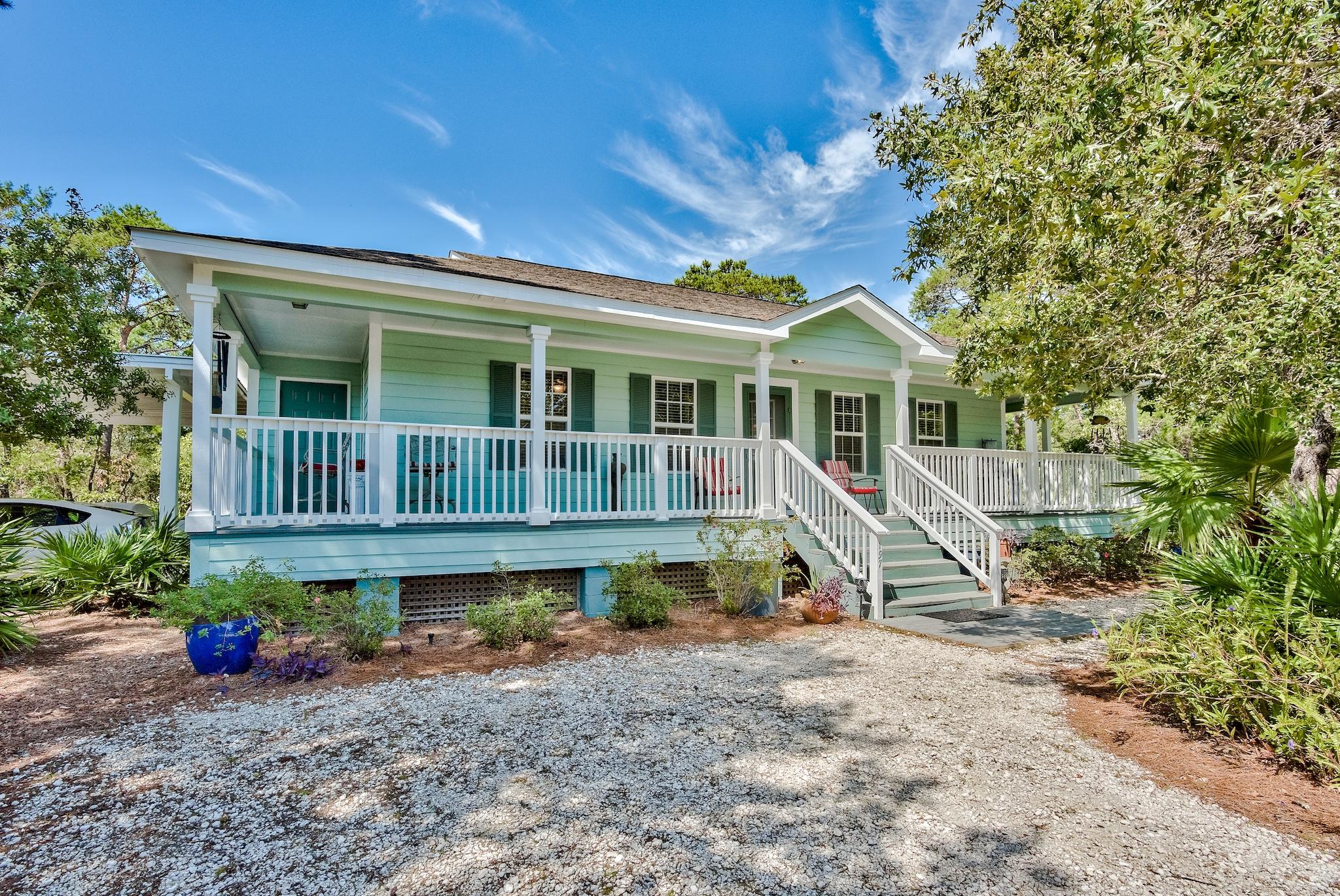 197 Acacia Street Santa Rosa Beach, FL 32459 - Photo 7 of 40 a house with wooden fence and deck