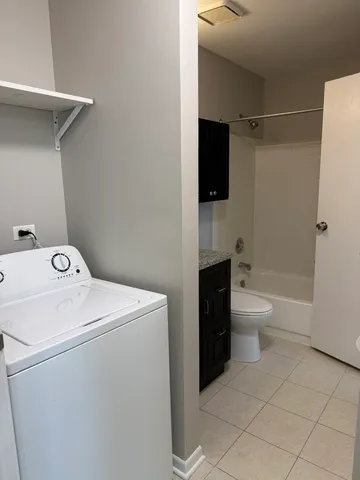 a view of bathroom with a washer and dryer