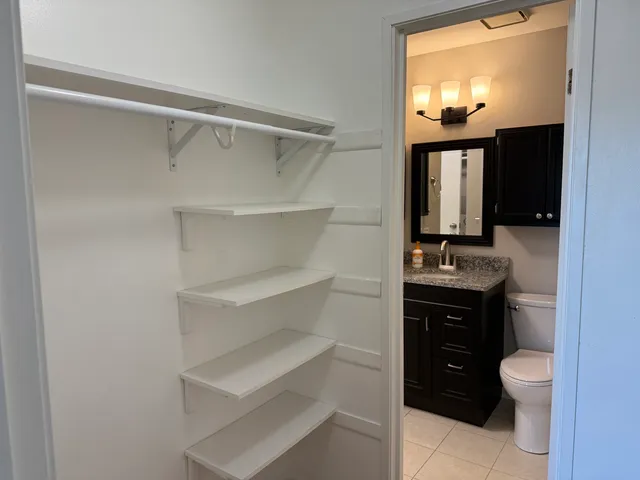 a bathroom with a sink toilet vanity and mirror