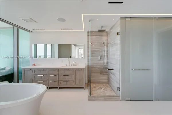 a bathroom with a double vanity sink mirror and shower
