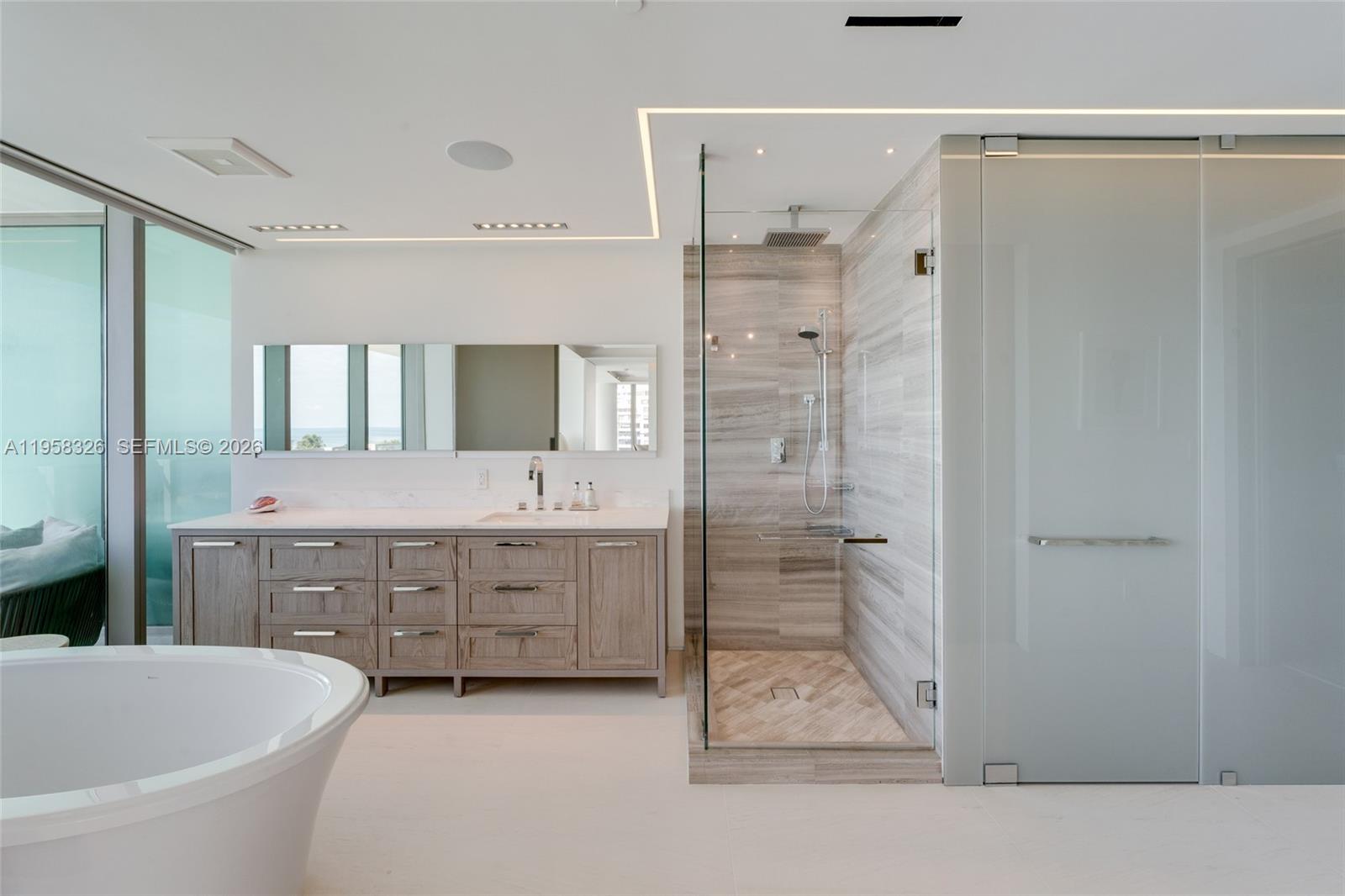 350 Ocean Drive, Unit 701N Key Biscayne, FL 33149 - Photo 11 of 52 a bathroom with a double vanity sink mirror and shower