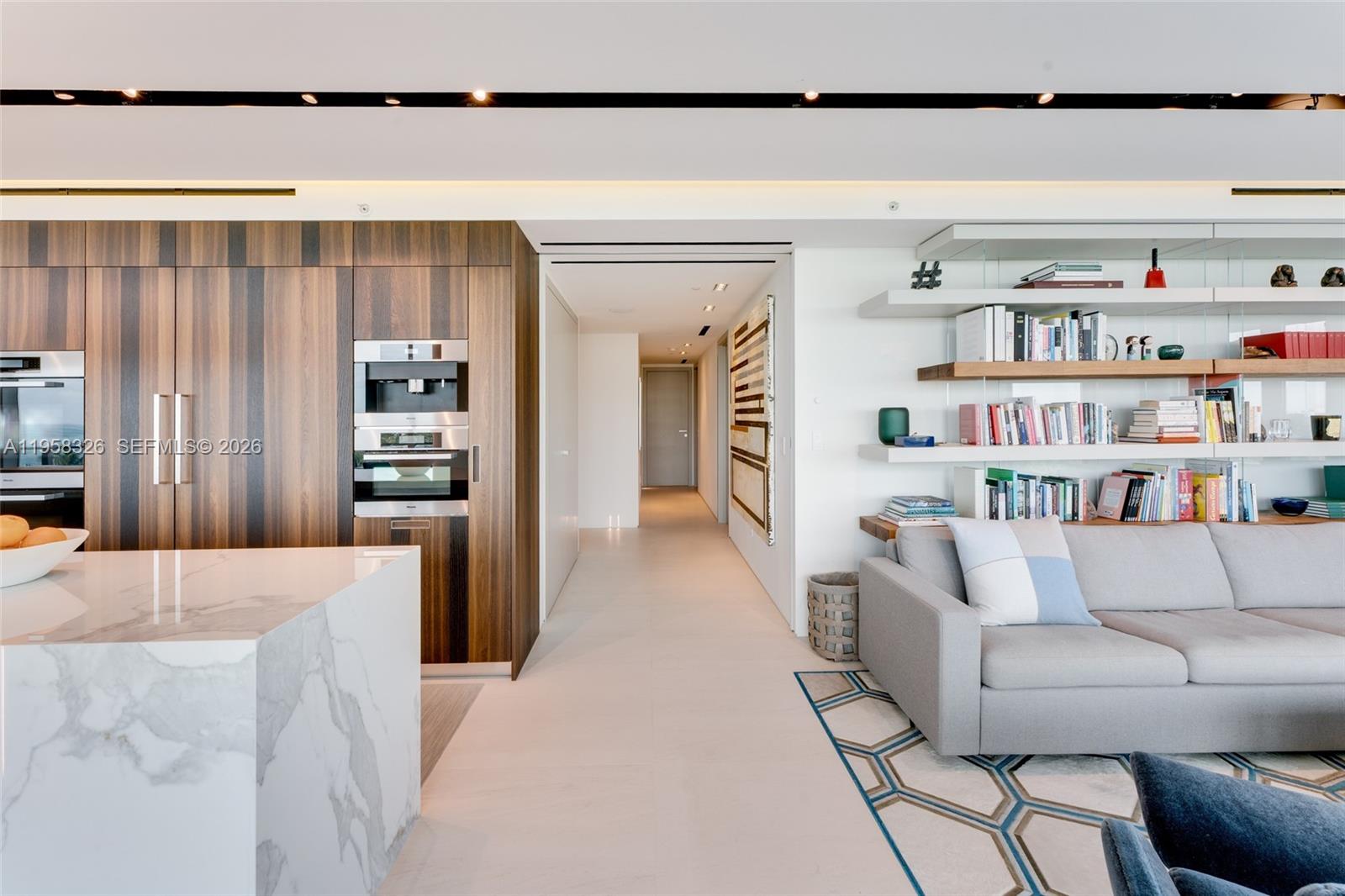 350 Ocean Drive, Unit 701N Key Biscayne, FL 33149 - Photo 18 of 52 a living room with furniture and a book shelf