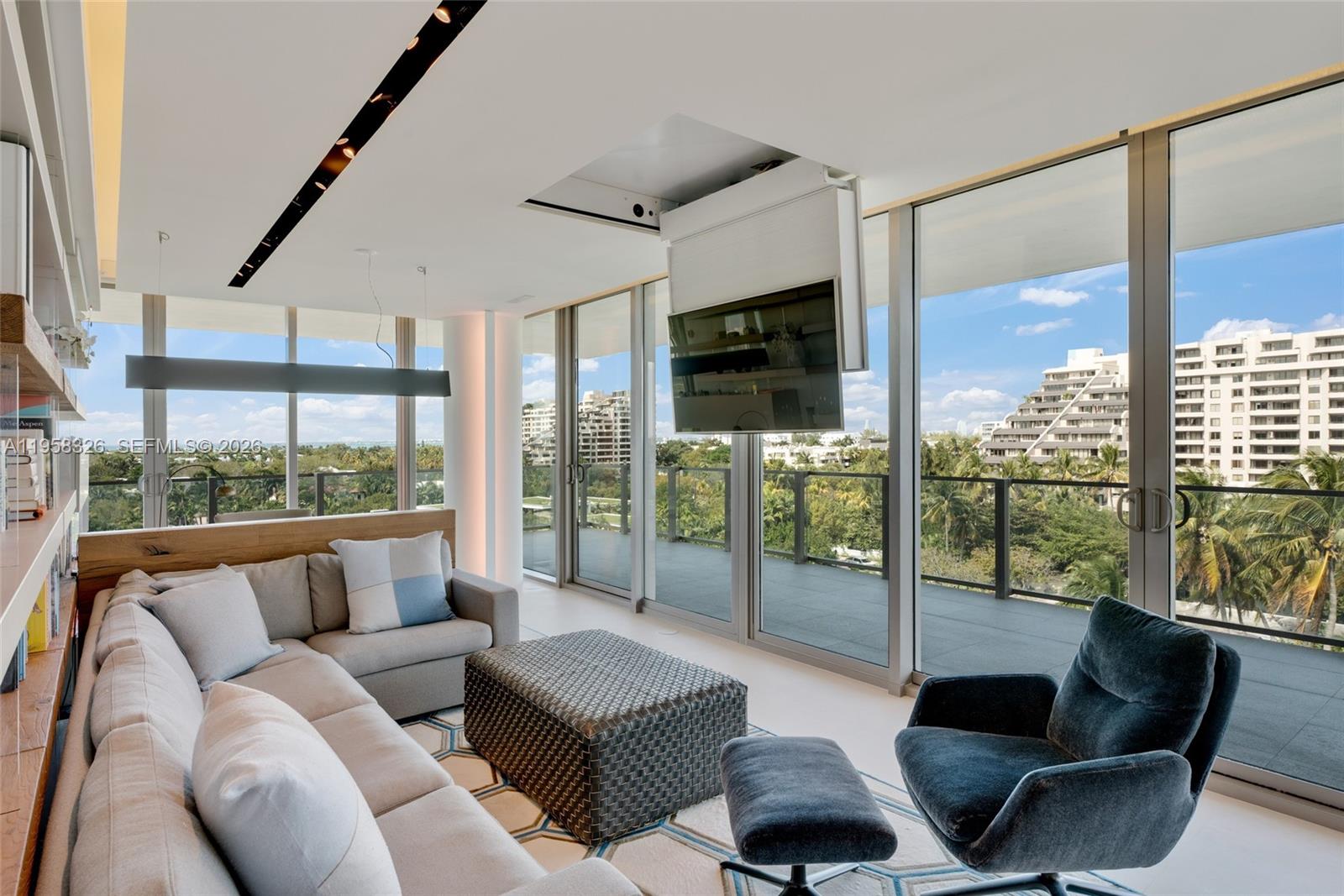 350 Ocean Drive, Unit 701N Key Biscayne, FL 33149 - Photo 20 of 52 a living room with furniture large windows and a flat screen tv