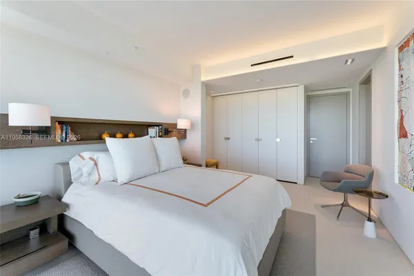 a bedroom with a bed and a lamp on table