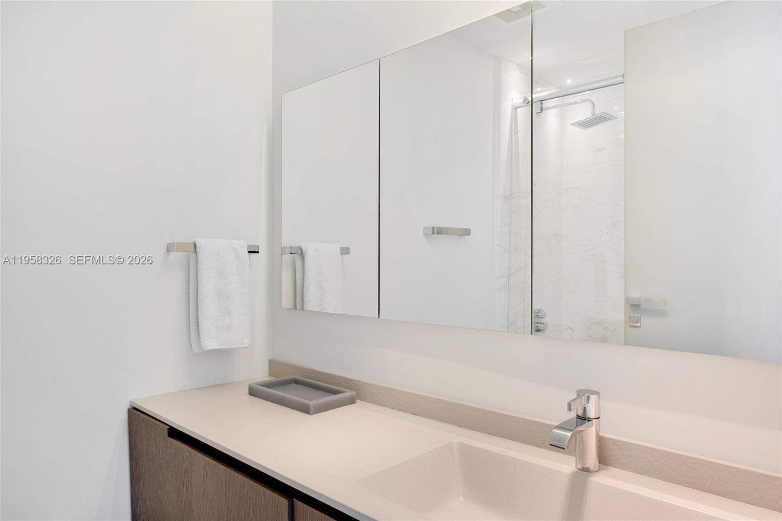 350 Ocean Drive, Unit 701N Key Biscayne, FL 33149 - Photo 24 of 52 a bathroom with a sink and a mirror