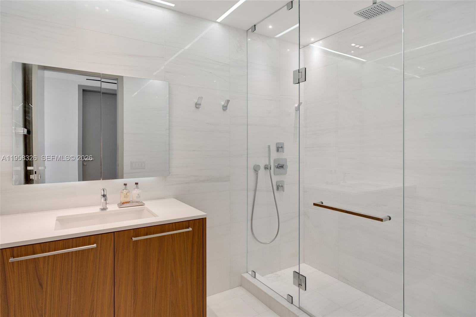 350 Ocean Drive, Unit 701N Key Biscayne, FL 33149 - Photo 27 of 52 a bathroom with a sink a toilet and shower