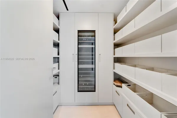 a view of walk in closet with empty racks