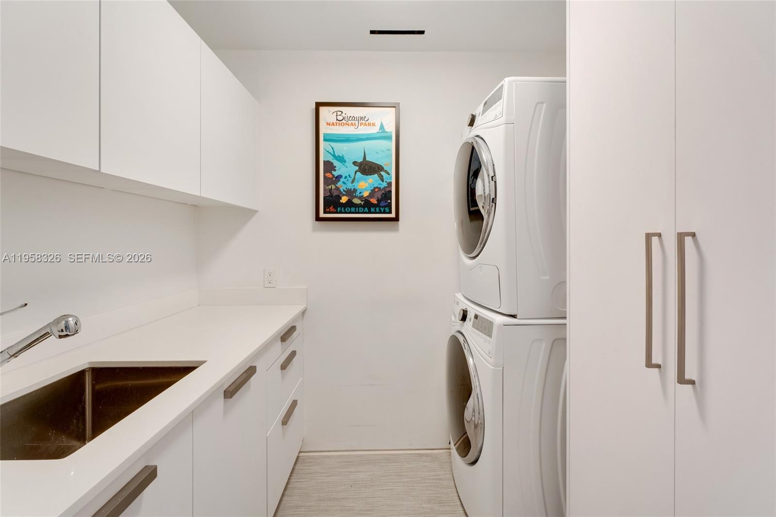 350 Ocean Drive, Unit 701N Key Biscayne, FL 33149 - Photo 34 of 52 a utility room with dryer and washer
