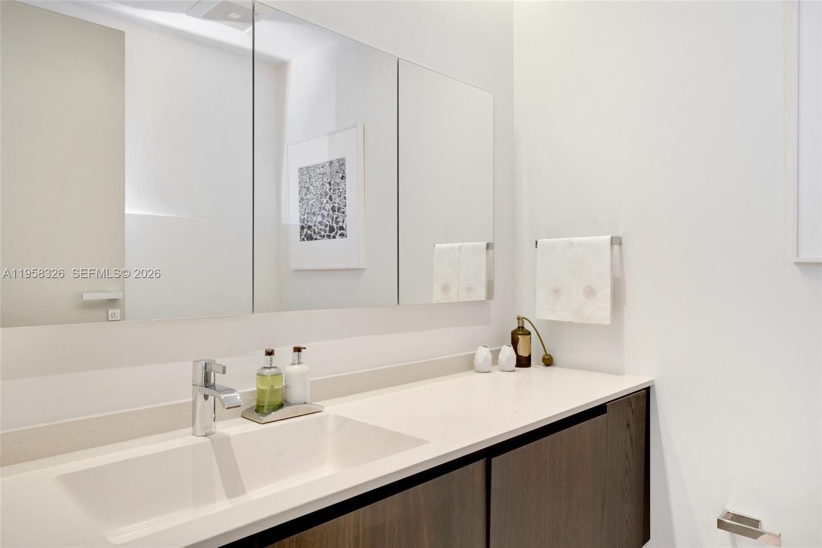 350 Ocean Drive, Unit 701N Key Biscayne, FL 33149 - Photo 35 of 52 a bathroom with a sink and a mirror