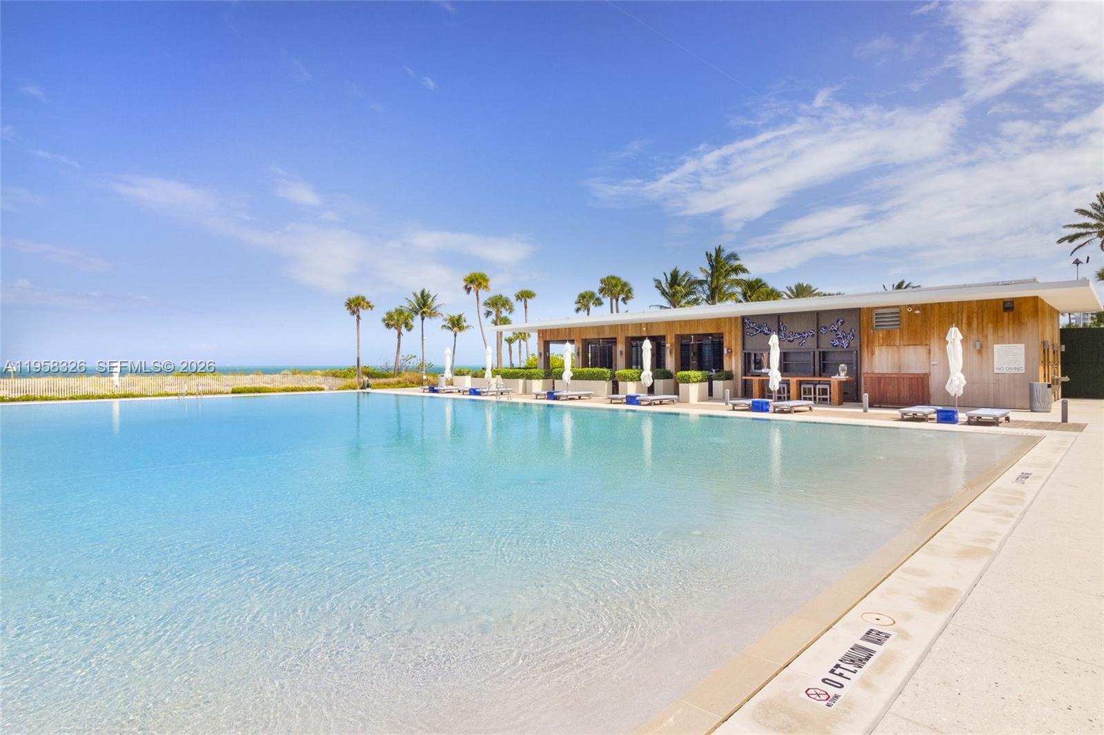350 Ocean Drive, Unit 701N Key Biscayne, FL 33149 - Photo 45 of 52 a view of a swimming pool and an outdoor seating