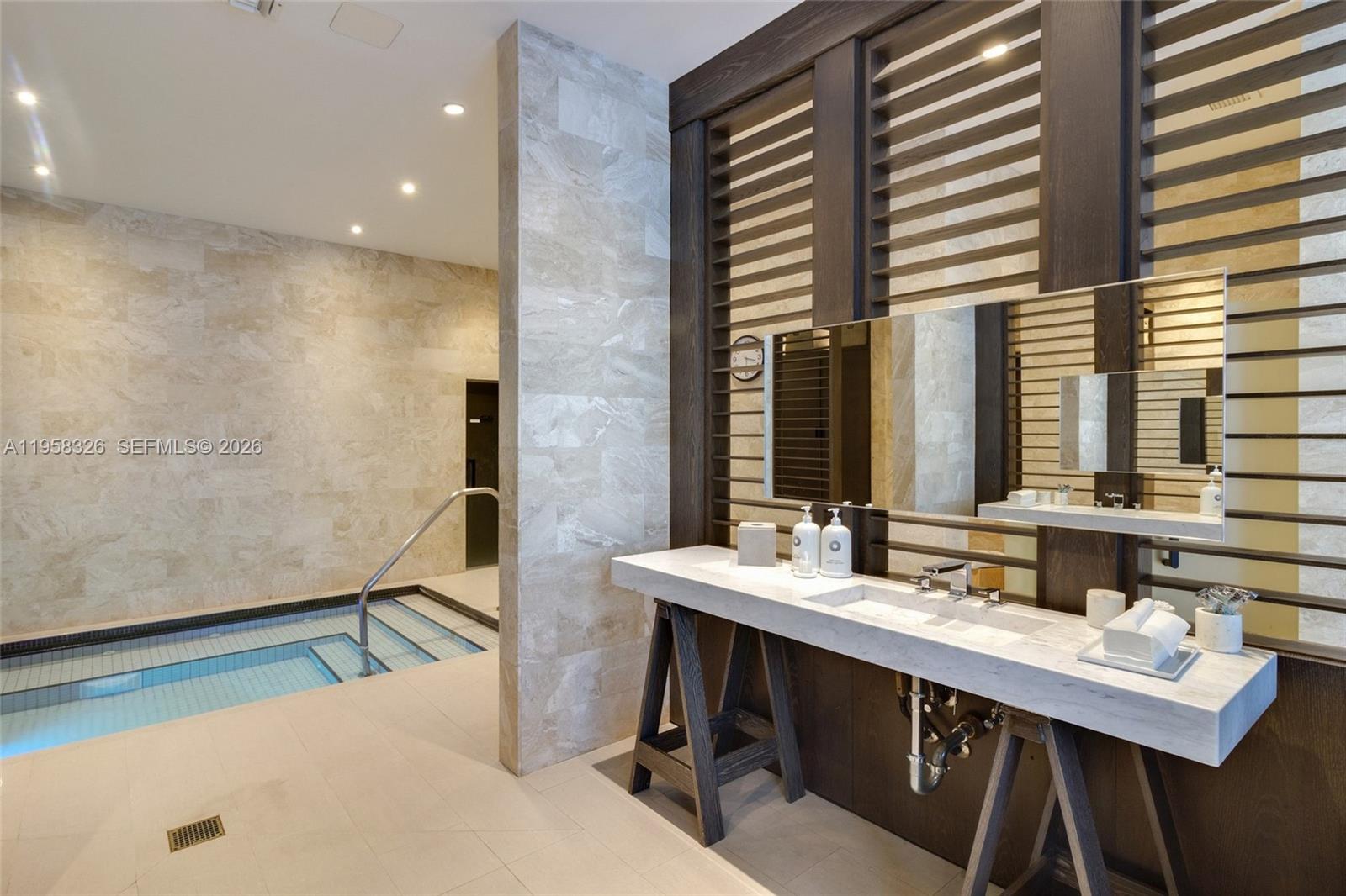 350 Ocean Drive, Unit 701N Key Biscayne, FL 33149 - Photo 49 of 52 a bathroom with a double vanity sink and a mirror