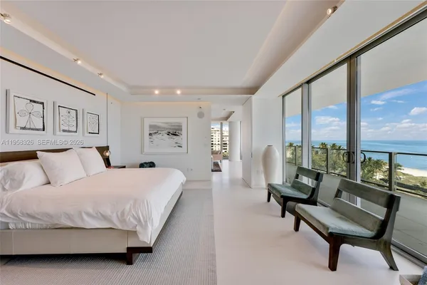 a spacious bedroom with a bed and a large window