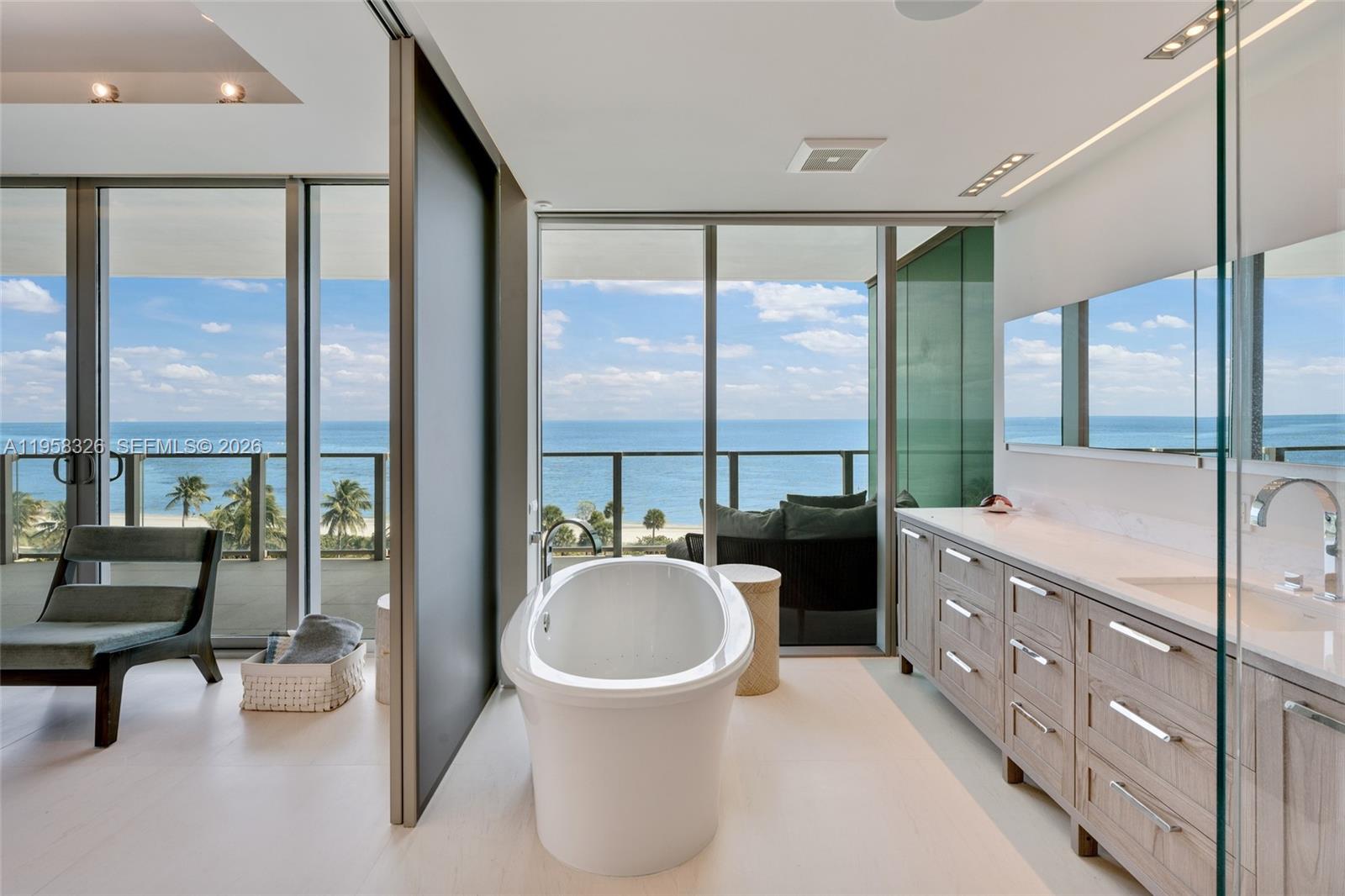 350 Ocean Drive, Unit 701N Key Biscayne, FL 33149 - Photo 10 of 52 a bathroom with a tub a sink and a large window