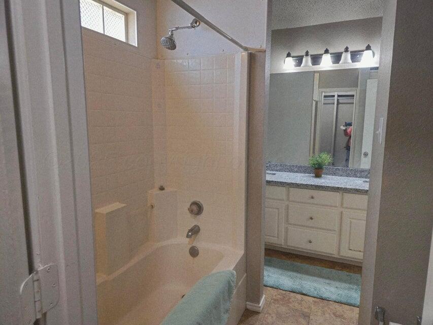 1918 75th Street Lubbock, TX 79423 - Photo 12 of 14 a bathroom with a bathtub sink vanity and mirror