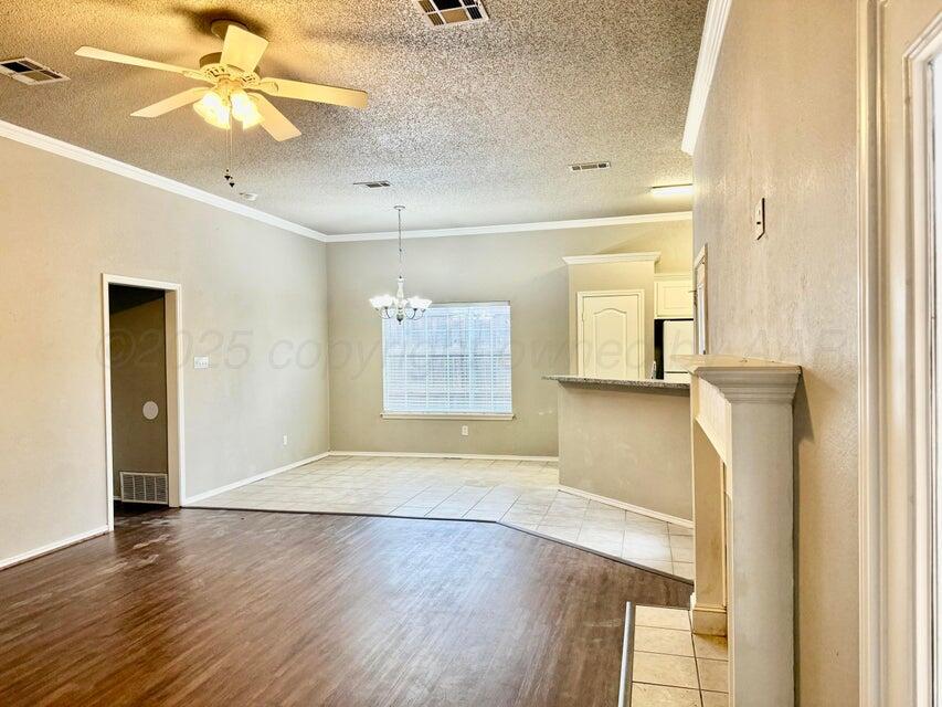 1918 75th Street Lubbock, TX 79423 - Photo 4 of 14 a view of empty room with wooden floor and fan