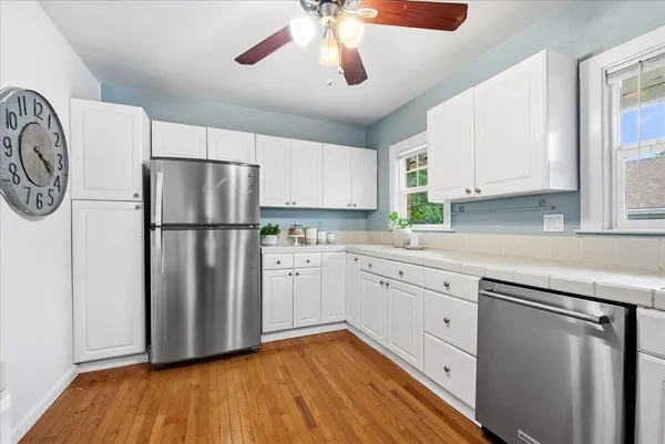 a kitchen with granite countertop a refrigerator and a sink