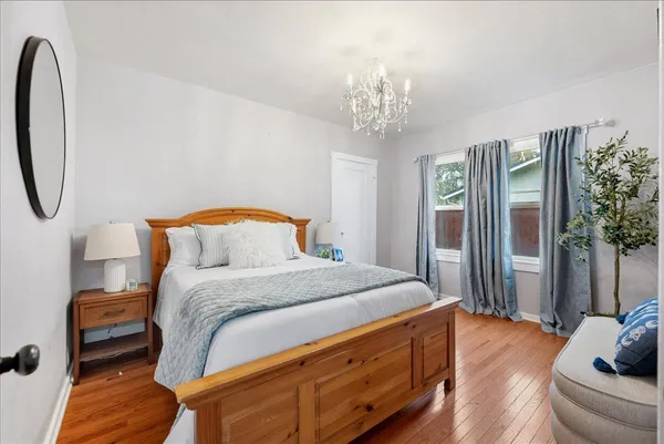 a bedroom with bed and a chandelier