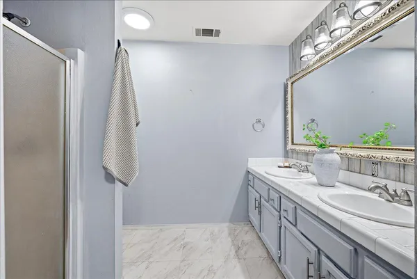 a bathroom with a double vanity sink and a mirror
