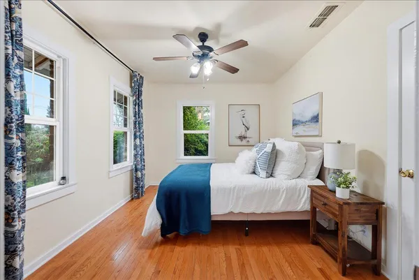 a bedroom with a bed and wooden floor