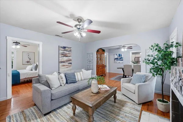 a living room with furniture and a chandelier