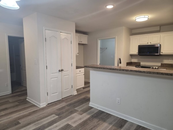 1556 Tylertown Road Clarksville, TN 37040 - Photo 5 of 10 a kitchen with granite countertop a sink and a stove top oven