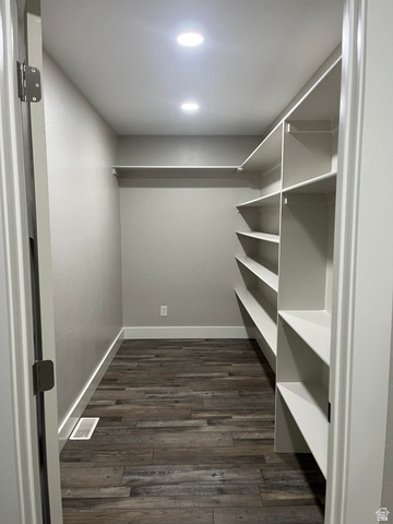 558 North N Cres Road Roosevelt, UT 84066 - Photo 25 of 31 Walk-in closet featuring built-in shelving, wood-finish flooring, recessed lighting, and a white baseboard trim