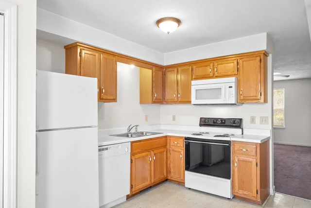 a kitchen with a stove a sink and a refrigerator