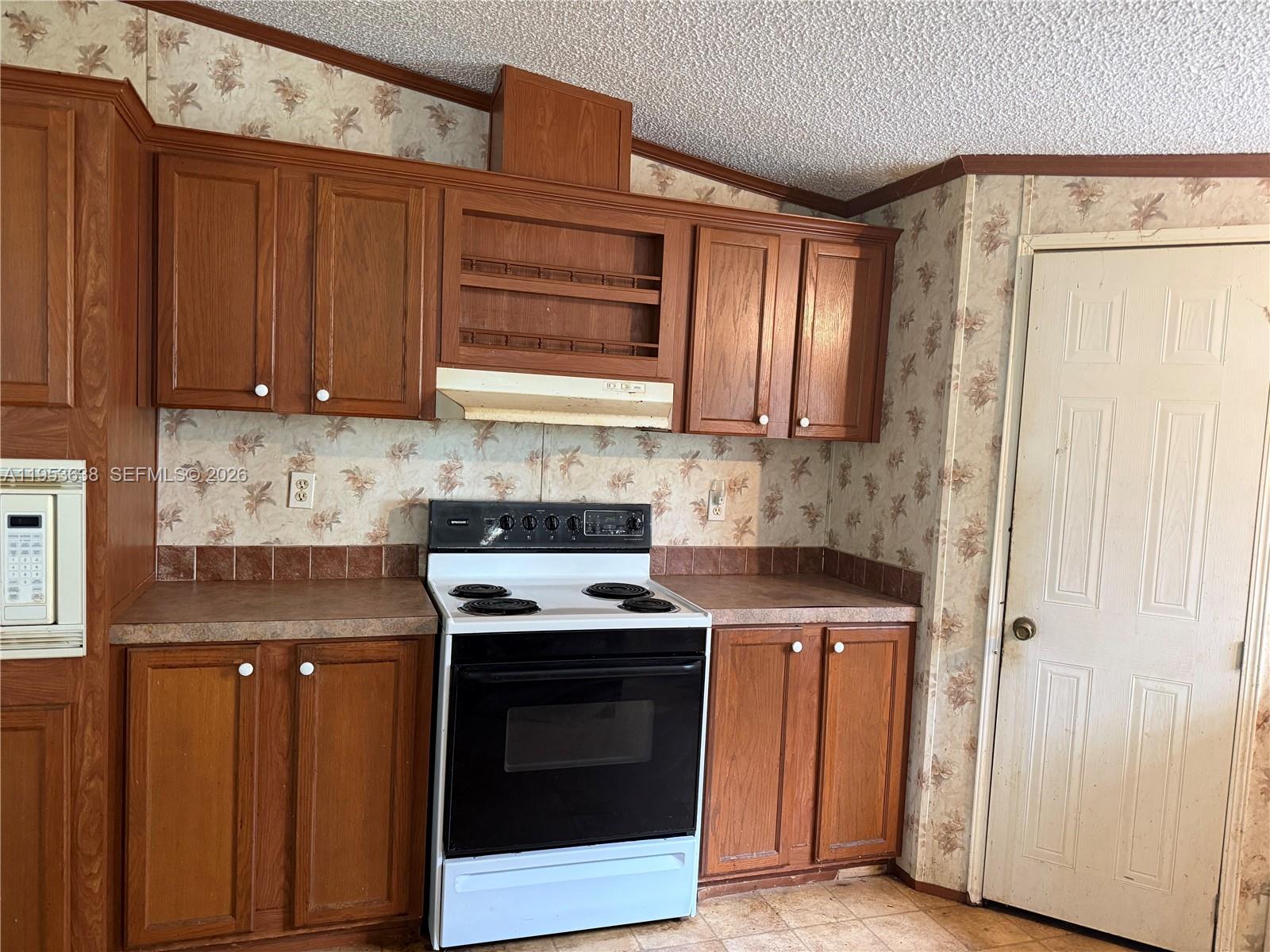 1980 Al Don Farming Road Clewiston, FL 33440 - Photo 12 of 26 a kitchen with stainless steel appliances granite countertop cabinets and a stove top oven