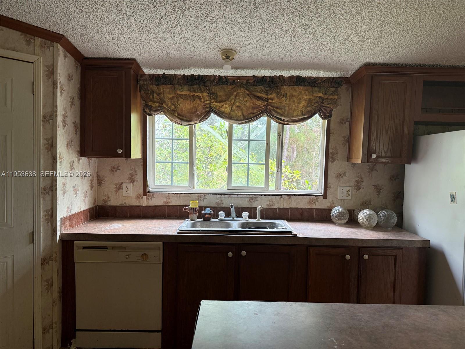 1980 Al Don Farming Road Clewiston, FL 33440 - Photo 14 of 26 a kitchen with a sink window and cabinets
