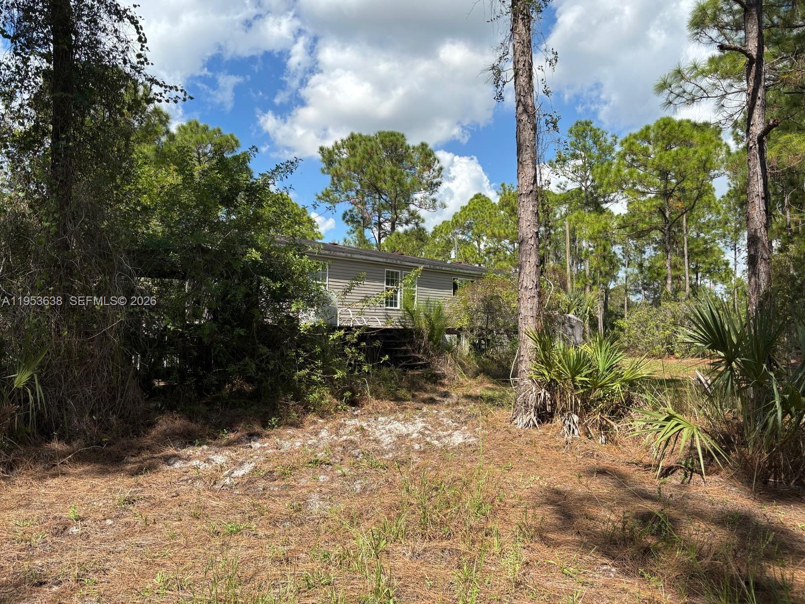 1980 Al Don Farming Road Clewiston, FL 33440 - Photo 2 of 26 a view of a pathway of a house with a yard