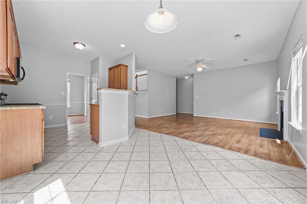 4712 Ridgefall Road Greensboro, NC 27410 - Photo 11 of 44 View of the living room and access to primary bedroom.