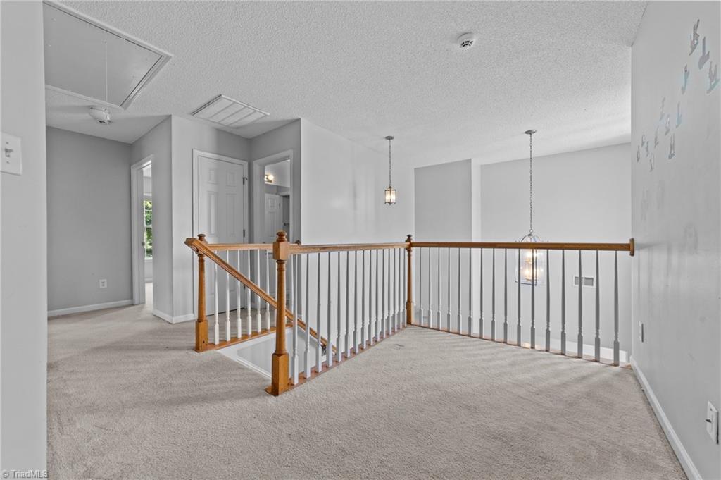 4712 Ridgefall Road Greensboro, NC 27410 - Photo 22 of 44 Second floor hallway with space open to below.